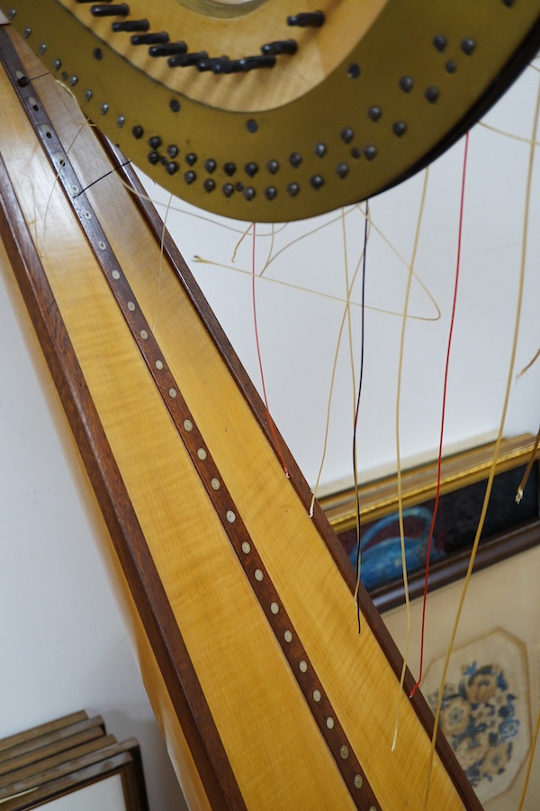 A Grecian satinwood seven pedal harp by J.C. Schwieso & Co., 19 Great Marlborough Street, Regent Street, London, numbered ‘824’, with brass makers plate and decorated with gilt mouldings, 173cm high
